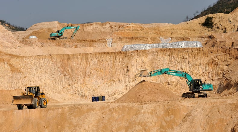FILE - Workers use machinery to dig at a rare earth mine in Ganxian county in central China's Jiangxi province on Dec. 30, 2010. (Chinatopix via AP, File)