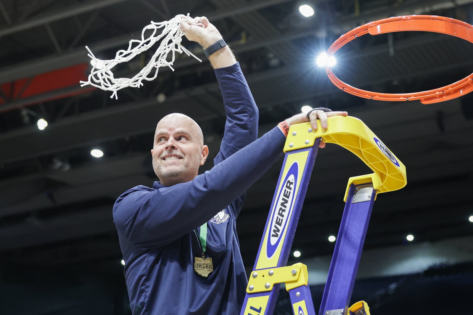 Fairmont coach Jeremy Finn twirls the net after cutting it down following the Firebirds' 61-55 overtime win over Princeton in the Division I state final on Saturday, March 14 at University of Dayton Arena. Finn is in his eighth season at the helm. BRYANT BILLING / STAFF