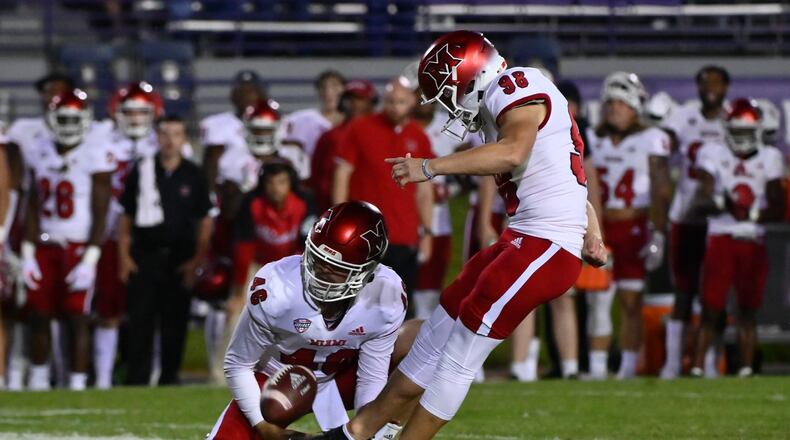 Miami (Ohio) place kicker Graham Nicholson (98) kicks the game-winning field goal against Northwestern from the hold of Alec Bevelhimer during the second half of an NCAA college football game Saturday, Sept. 24, 2022, in Evanston, Ill. (AP Photo/Matt Marton)