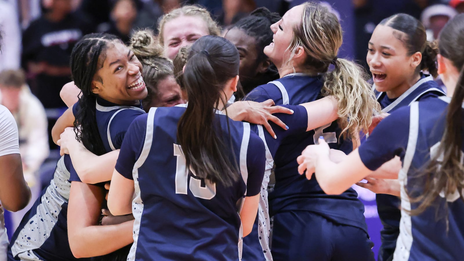 Fairmont senior guard Kaylah Thornton is mobbed by teammates during a celebration following the Firebirds' 61-55 victory over Princeton in the Division I state final on Saturday, March 14 at University of Dayton Arena. Thornton scored 19 points, including the game-tying 3 to send it to overtime. BRYANT BILLING / STAFF