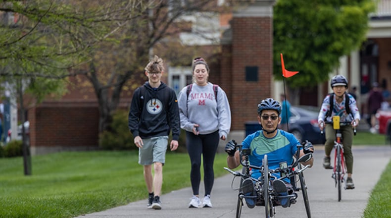 Miami University Associate Professor of Biology Yoshi Tomoyasu trains on his handcycle bike on the Miami University campus. He rides with his wife, Chie. CONTRIBUTE