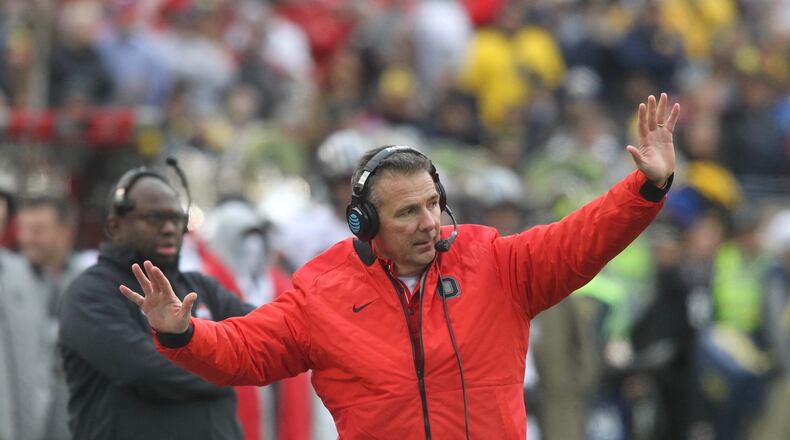 Ohio State's Urban Meyer talks to his players during a game against Michigan on Saturday, Nov. 25, 2017, at Michigan Stadium in Ann Arbor, Mich. David Jablonski/Staff