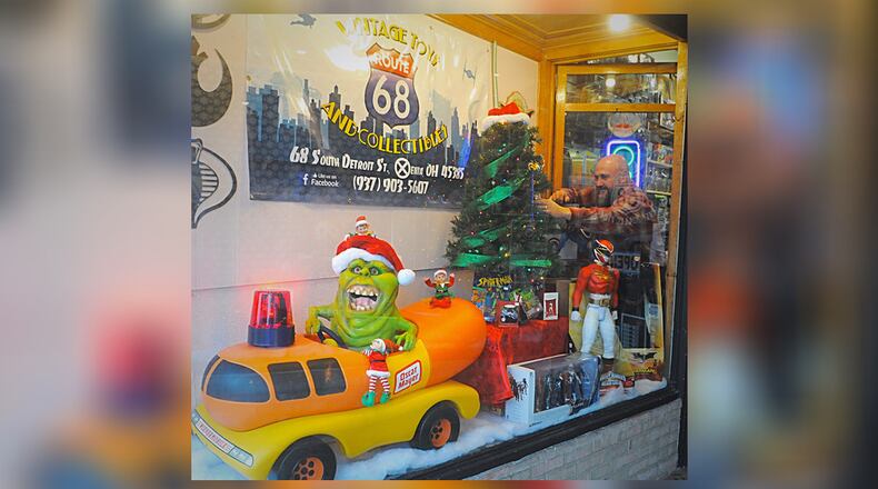 Rob Eldridge works on the display window at his business Route 68 Vintage Toys and Collectibles during the Xenia s Hometown Christmas Saturday Nov. 23, 2019.
