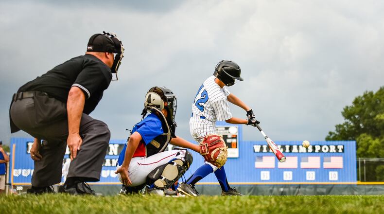 Hamilton West Side’s Eddie Tanner gets a piece of the ball during Tuesday night’s winners’ bracket final against Hamilton-Fairfield in the District 9 tournament at the West Side complex. NICK GRAHAM/STAFF