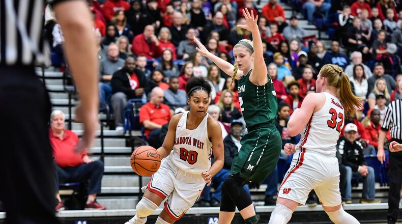 Lakota West’s Jaydis Gales dribbles to the hoop as Mason’s Sammie Puisis defends during their Division I regional final March 10, 2018, at Fairmon’ts Trent Arena. NICK GRAHAM/STAFF