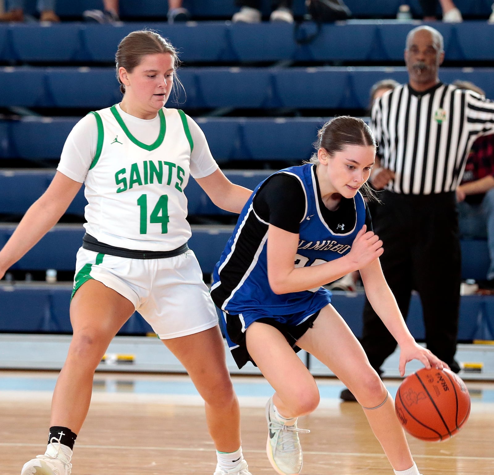 Miamisburg freshman Lex Pringle tries to dribble around Seton senior Taylor Hummeldorf. Seton defeated Miamisburg 60-29 in a Division II district championship game on Saturday, Feb. 28, 2026, in Fairborn. STEVEN WRIGHT / STAFF