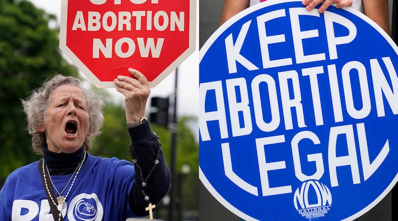 A woman holds a sign saying "stop abortion now," at a protest outside of the U.S. Supreme Court in Washington on May 5, 2022, left, and another woman holds a sign during a news conference for reproductive rights in response to the leaked draft of the Supreme Court's opinion to overturn Roe v. Wade, in West Hollywood, Calif., on March 3, 2022. (AP Photo)