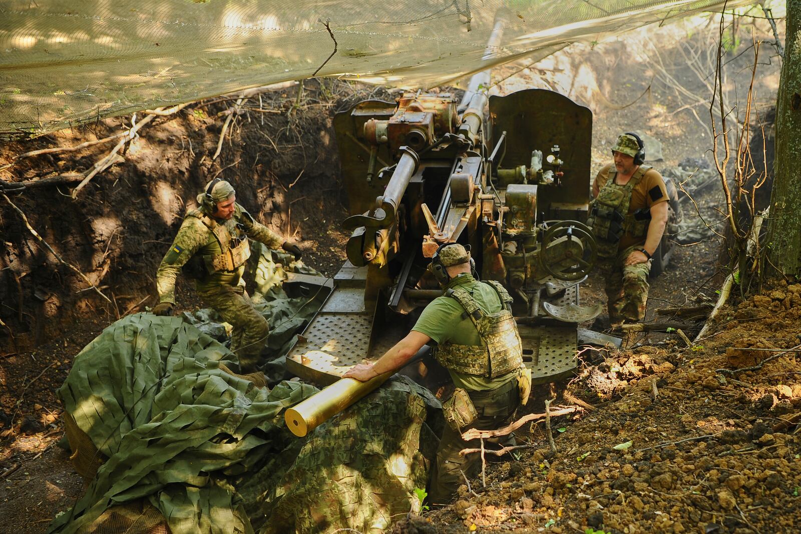 In this photo provided by Ukraine's 127th Separate Brigade of the Territorial Defence press service, soldiers fire a canon towards Russian army positions near Kharkiv, Ukraine, Monday, June 2, 2025, (Anatolii Lysianskyi/Ukraine's 127th Separate Brigade via AP)