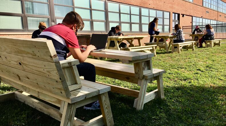Hamilton High School students in the school's Butler Tech carpentry class are helping their classmates by building picnic tables to allow their classmates to study outside the school when weather permits. The tables, say students, are a welcomed break from only learning inside classrooms during the coronavirus. (Photo By Michael D. Clark\Journal-News)