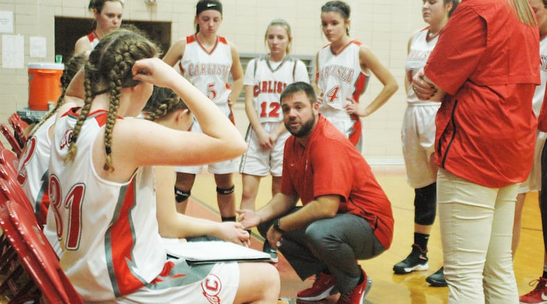 Carlisle coach Tony Phillips talks to his team in a timeout Friday night during a season-opening 49-20 victory over Twin Valley South in 2018. FILE PHOTO