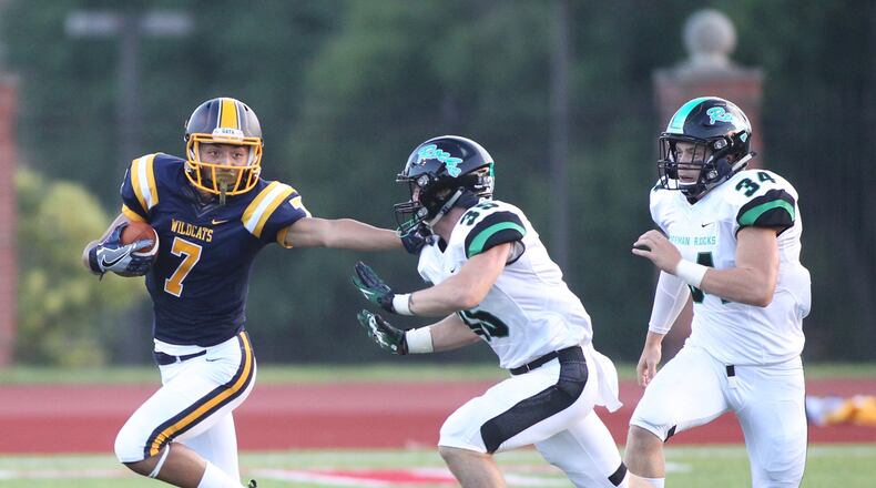 Springfield’s Danny Davis, left, gives a stiff arm to Dublin Coffman’s Jack Hamilton on Friday, Aug. 26, 2016, at Edwards-Maurer Field in Springfield. David Jablonski/Staff
