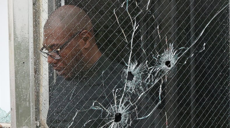 Glen Willians, the owner of the business on South Yellow Springs Street where six people were shot early Wednesday morning, walks out of his business after surveying the damage. BILL LACKEY/STAFF