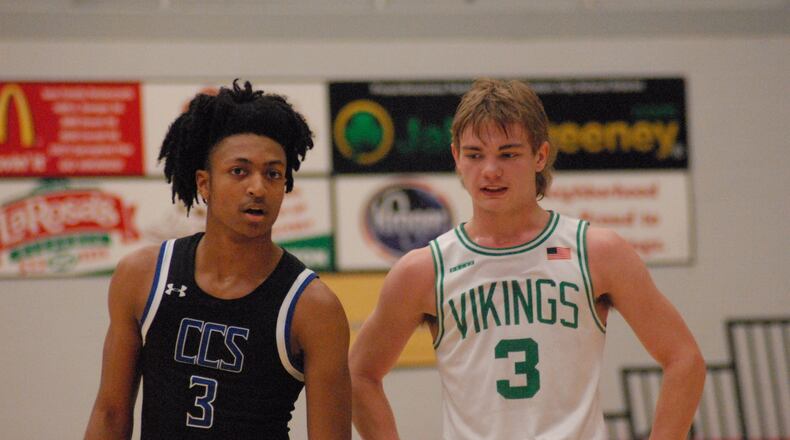 Cincinnati Christian senior Corey Rogers and New Miami sophomore Dalson Hayes chat it up during their Division IV sectional contest on Monday night at Princeton. CCS won 67-29. Chris Vogt/CONTRIBUTED
