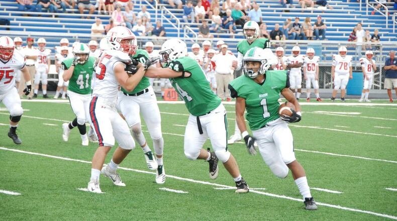 Badin’s Davon Starks (1) gets a block from teammate Andrew Jones last Friday night against Talawanda at Hamilton’s Virgil Schwarm Stadium. Inclement weather forced the game to be completed at Talawanda on Saturday, with Badin winning 38-7. CONTRIBUTED PHOTO BY OLIVER SANDERS