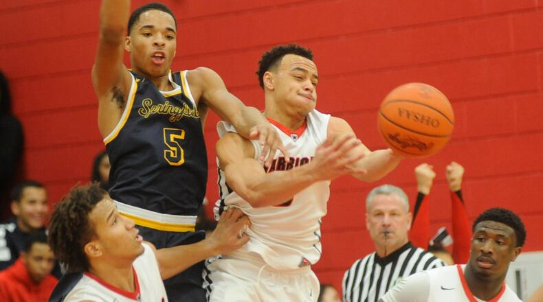 Springfield’s Raheim Moss (5) and Darius Quisenberry (middle) of Wayne were chosen to the D-I All-Ohio boys basketball teams. MARC PENDLETON / STAFF