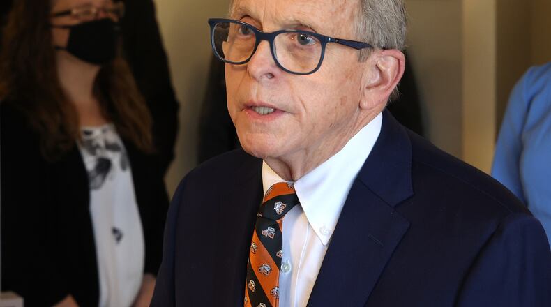 Governor Mike DeWine speaks to members of the media as he tours the vaccination clinic at New Carlisle Senior Living Friday morning. BILL LACKEY/STAFF