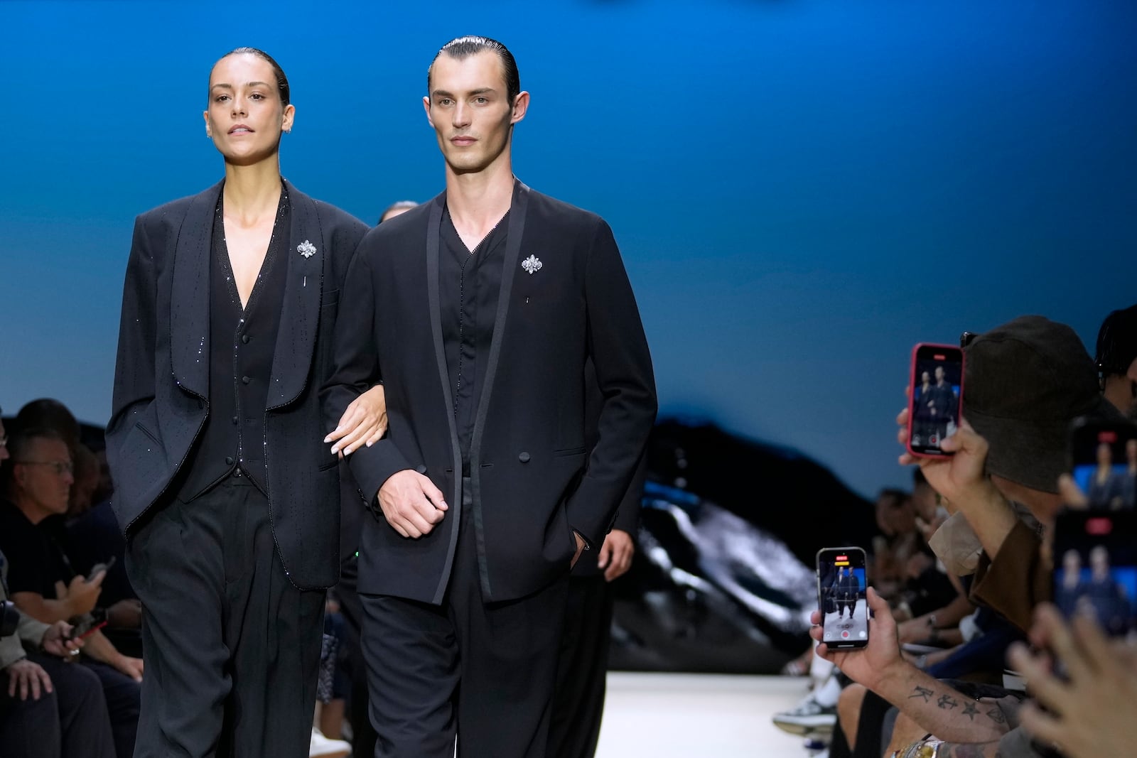 Models wear creations as part of the men's Giorgio Armani Spring-Summer 2026 collection, that was presented in Milan, Italy, Monday, June 23, 2025. (AP Photo/Luca Bruno)