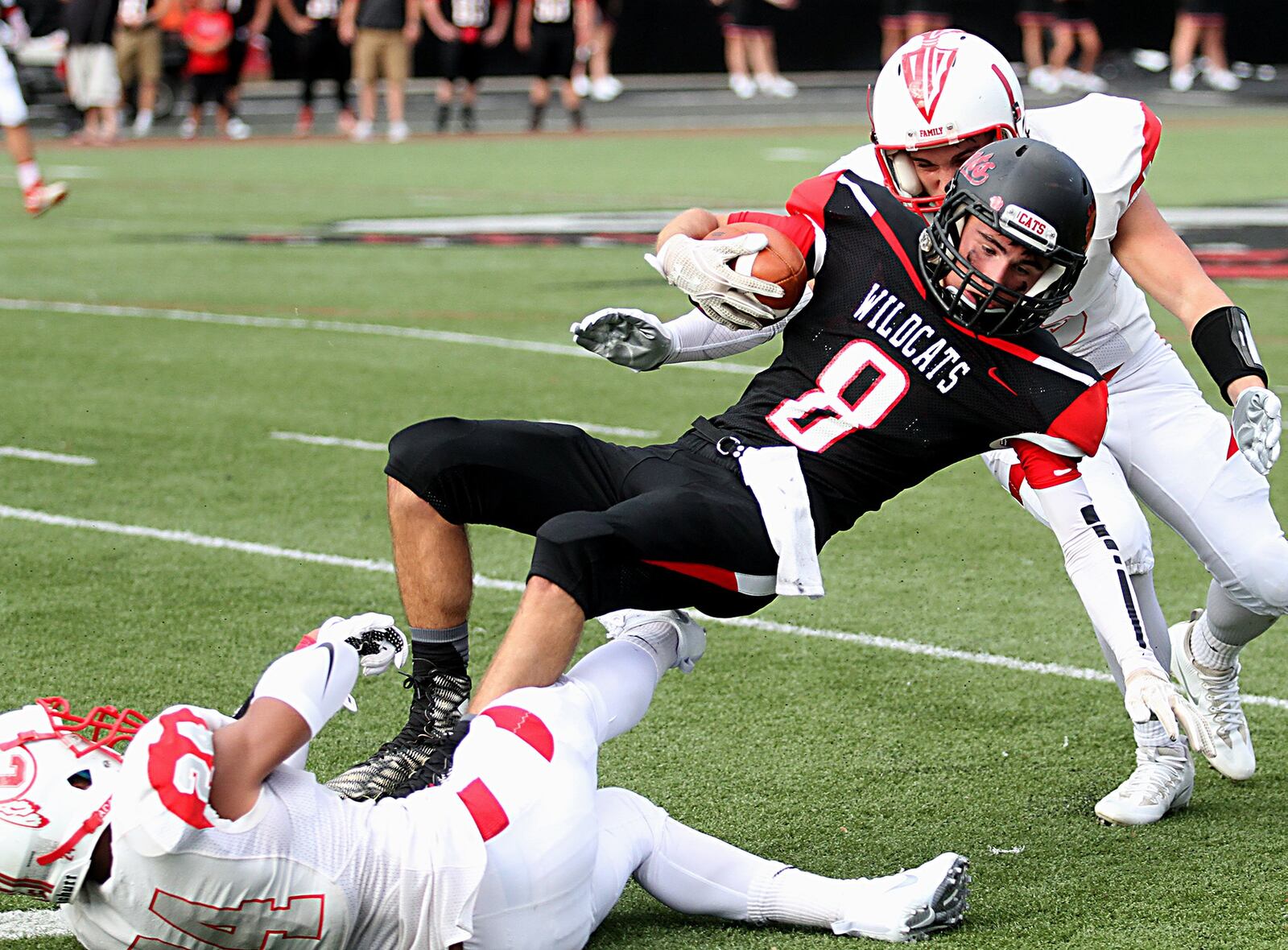 Franklin wide receiver Austin Gilbert is brought down by Carlisle’s Zayne Hart and Dakota Milligan at Atrium Stadium in the season opener. Franklin is No. 5 in the Division III state poll. CONTRIBUTED PHOTO BY E.L. HUBBARD