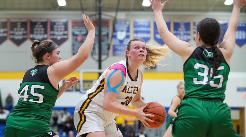 Alter High School's Maddie Moody is defended by Hamilton Badin sophomore Brooke Sebastian (left) and senior Lauren Christie during a Division II regional semifinal game on Tuesday, Feb. 28, 2023 at Springfield High School. Michael Cooper/CONTRIBUTED