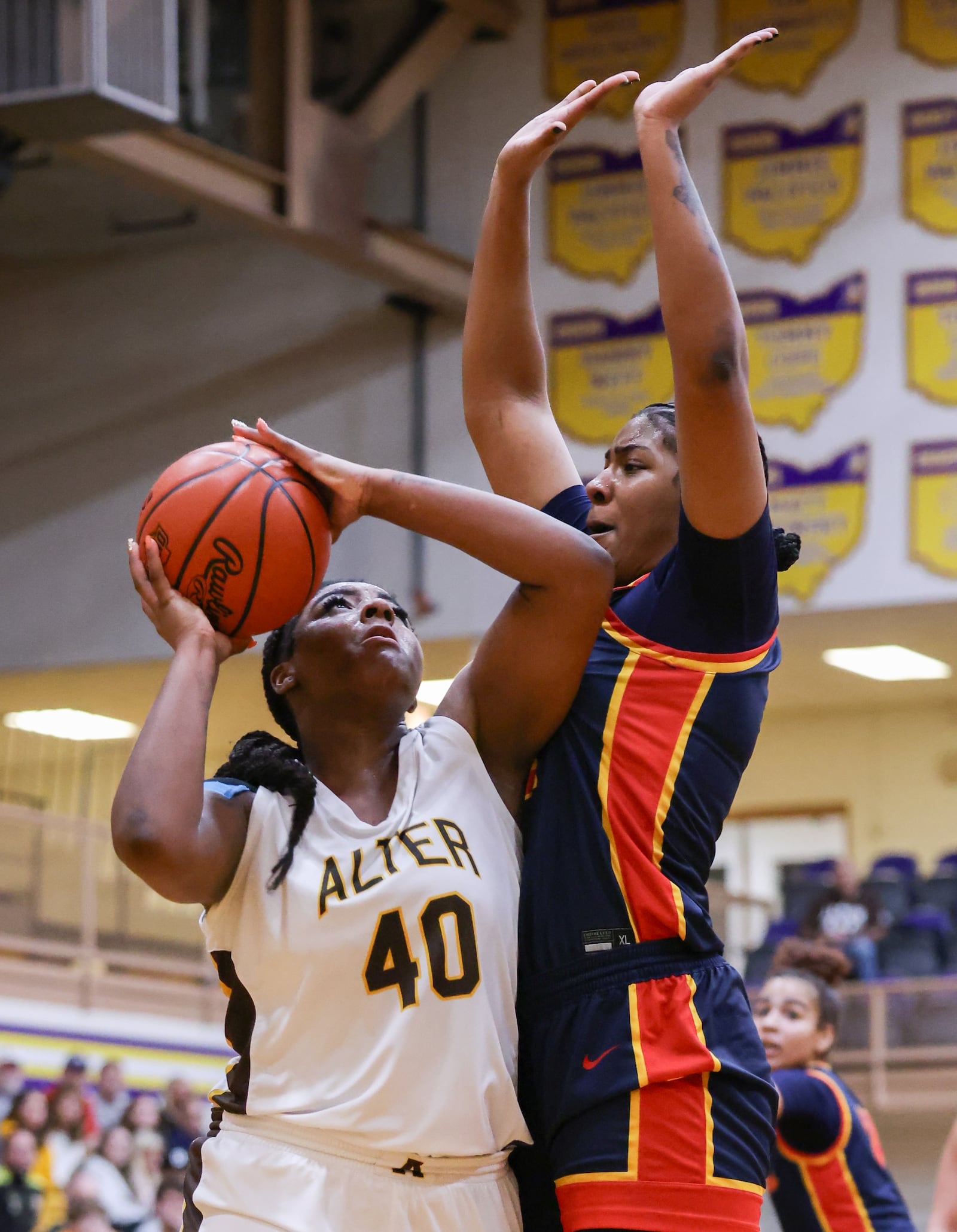 Alter senior forward Da'Shai Shepard shoots with pressure from Cincinnati Purcell Marian's Samaya Wilkins during a Division IV regional final on Saturday, March 7 at Vandalia-Butler's Student Activity Center. BRYANT BILLING / STAFF