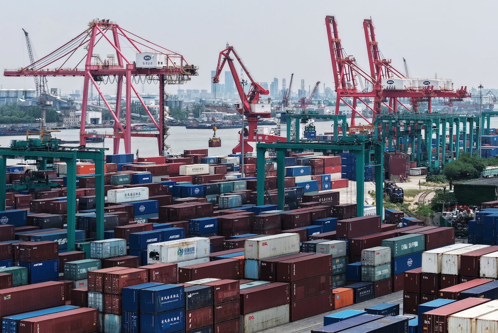FILE - Machines loading container at a container terminal, in Shanghai, China on Wednesday, May 14, 2025. (Chinatopix Via AP,File)