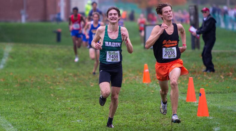 Badin's Dominic Seigel (left) battles Dylan Lauck to the finish line of the Division II boys race in Saturday's regional meet in Troy. Jeff Gilbert/CONTRIBUTED