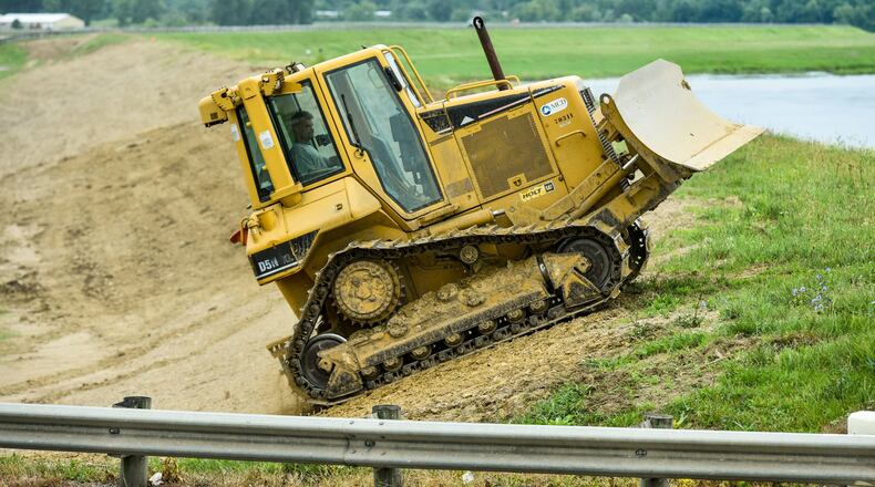 The levy along the Great Miami River in Middletown is being leveled to make it easier to mow and maintain, says Kurt Rinehart, civil engineer of the Miami Conservancy District. NICK GRAHAM/STAFF