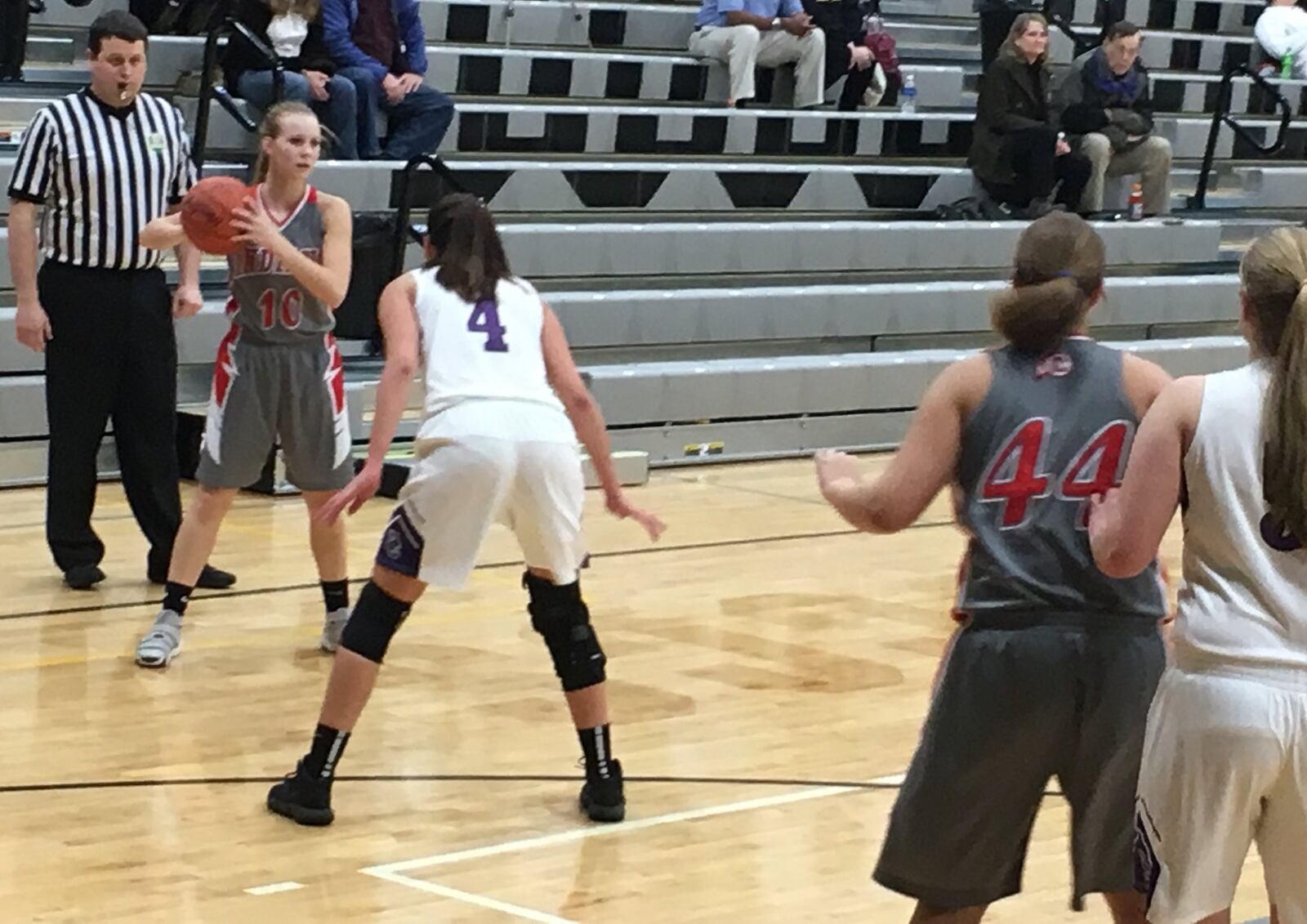 Carlisle’s Christa Harris (10) looks toward teammate Cami Glover (44) as Dayton Christian’s Casey Darkow (4) and Camryn Collinsworth (5) defend during Wednesday night’s Division III sectional semifinal at Covington. RICK CASSANO/STAFF