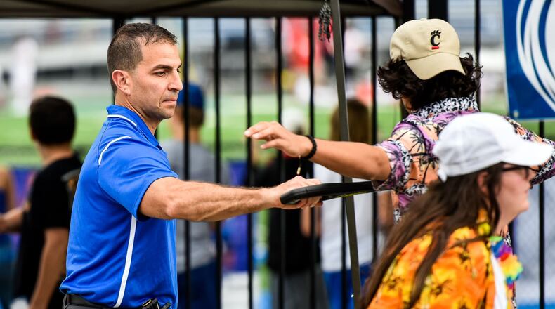 Hamilton High School Principal John Wilhelm uses a metal detector wand to check students at the student entrance before their football game against Fairfield Friday, Sept. 7 at Hamilton High School’s Virgil M. Schwarm Stadium in Hamilton. School officials throughout Southwest Ohio and beyond will be closely watching the outcome of Butler County’s first experiment in school districts banding together to seek a tax hike.