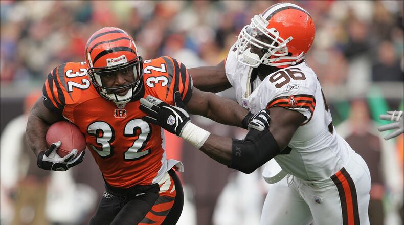 CINCINNATI - NOVEMBER 28: Running back Rudi Johnson #32 of the Cleveland Browns evades defensive end Kenard Lang #96 of the Cincinnati Bengals during the game at Paul Brown Stadium on November 28, 2004 in Cincinnati, Ohio. The Bengals defeated the Browns 58-48. (Photo by Andy Lyons/Getty Images) *** Local Caption *** Rudi Johnson;Kenard Lang