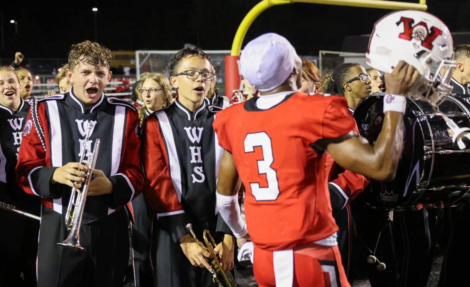 Wayne's Semarion Sroufe celebrates with band members following the Warriors' 31-24 win over Fairfield in a nonconference game on Friday, Aug. 22 at Heidkamp Stadium in Huber Heights. Wayne scored a late touchdown and held on to win. BRYANT BILLING / STAFF
