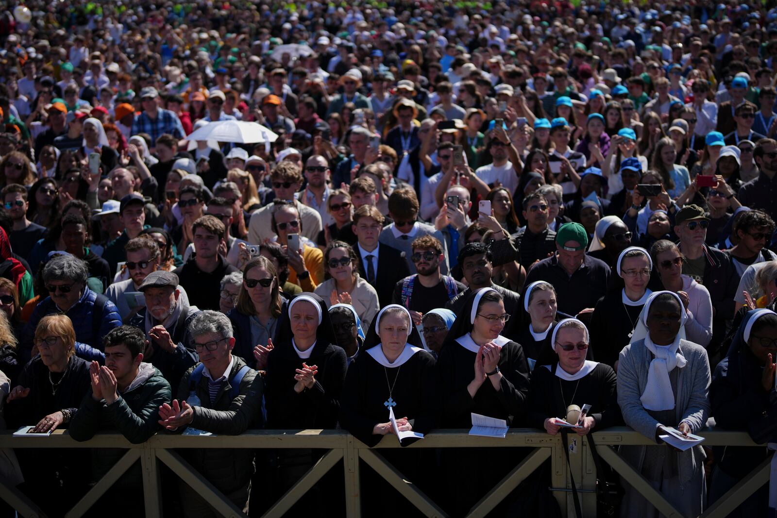 Nuns and faithful listen to mass during the funeral of Pope Francis in St. Peter's Square at the Vatican, Saturday, April 26, 2025. (AP Photo/Emilio Morenatti)