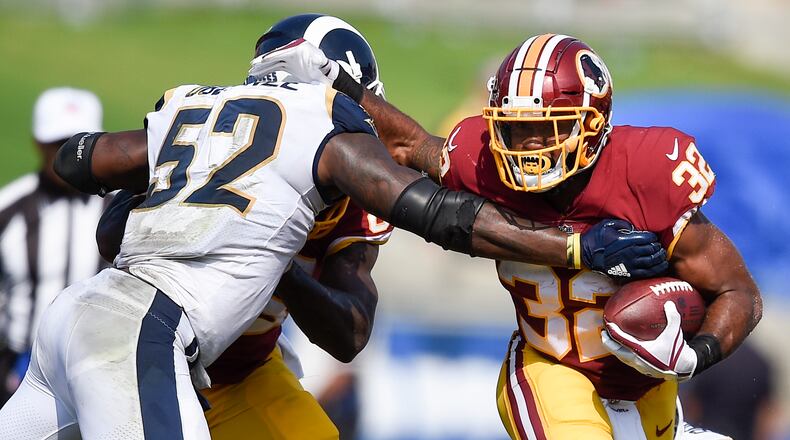 FILE - In this Sept. 17, 2017 file photo, Washington Redskins running back Samaje Perine (32) in action defended by Los Angeles Rams linebacker Alec Ogletree (52) during the second half of an NFL football game in Los Angeles. (AP Photo/Kelvin Kuo)