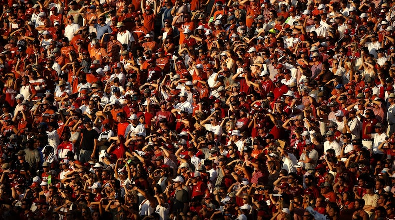 Texas and Oklahoma fans watch during the second half of an NCAA college football game Saturday, Oct. 14, 2017, in Dallas. Oklahoma won 29-24. (AP Photo/Ron Jenkins)