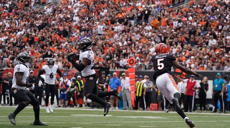 Baltimore Ravens safety Geno Stone (26) intercepts a pass intended for Cincinnati Bengals wide receiver Tee Higgins (5) during the second half of an NFL football game Sunday, Sept. 17, 2023, in Cincinnati. (AP Photo/Darron Cummings)