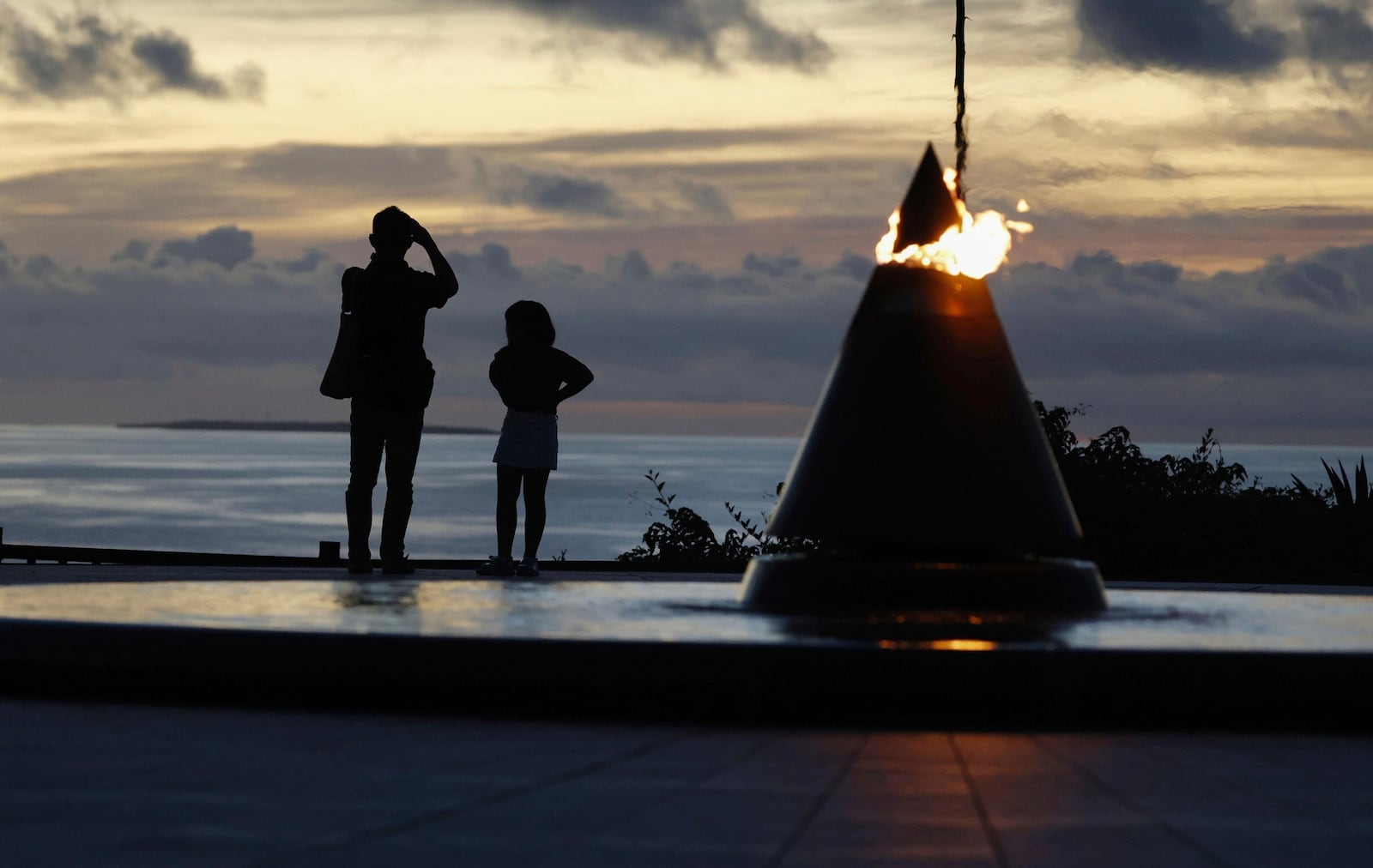 Visitors look towards the sea at the Peace Memorial Park in Itoman, Okinawa prefecture, southern Japan Monday, June 23, 2025 as Japan marked the 80th anniversary of the end of the Battle of Okinawa. (Haruna Furuhashi/Kyodo News via AP)