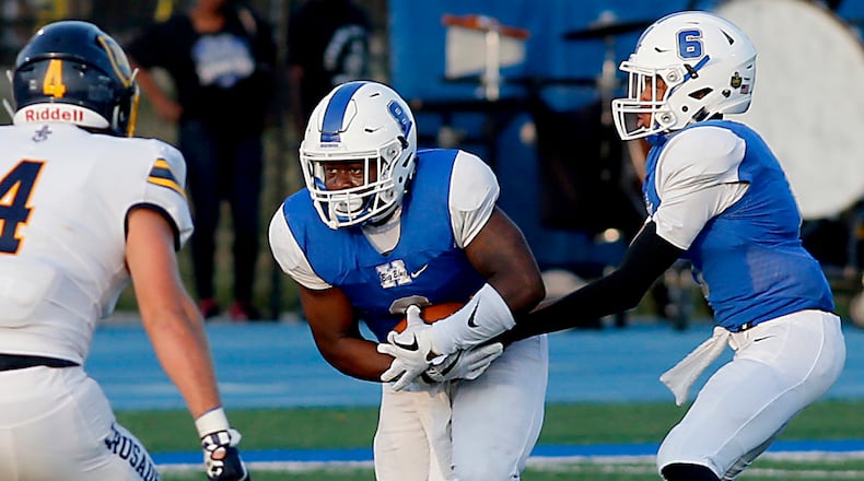 Hamilton’s Maleek Jarrett takes the handoff from Khaliyal Sowell during a Skyline Chili Crosstown Showdown game against Moeller at Virgil Schwarm Stadium in Hamilton on Aug. 26. HHS lost 42-7. CONTRIBUTED PHOTO BY E.L. HUBBARD