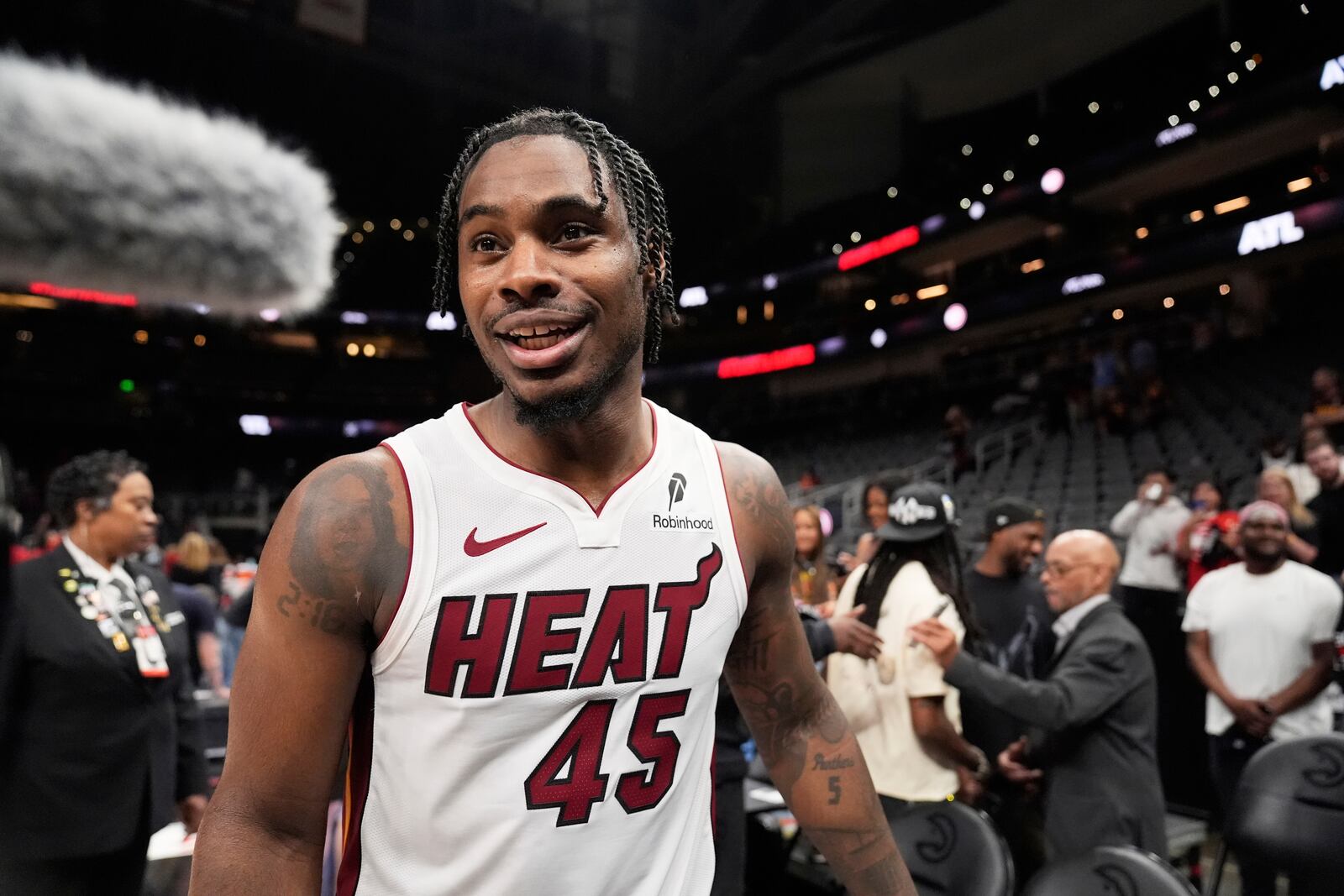 Miami Heat guard Davion Mitchell (45) leaves the court after a win against the Atlanta Hawks, after an NBA play-in tournament basketball, Friday, April 18, 2025, in Atlanta. (AP Photo/Brynn Anderson)