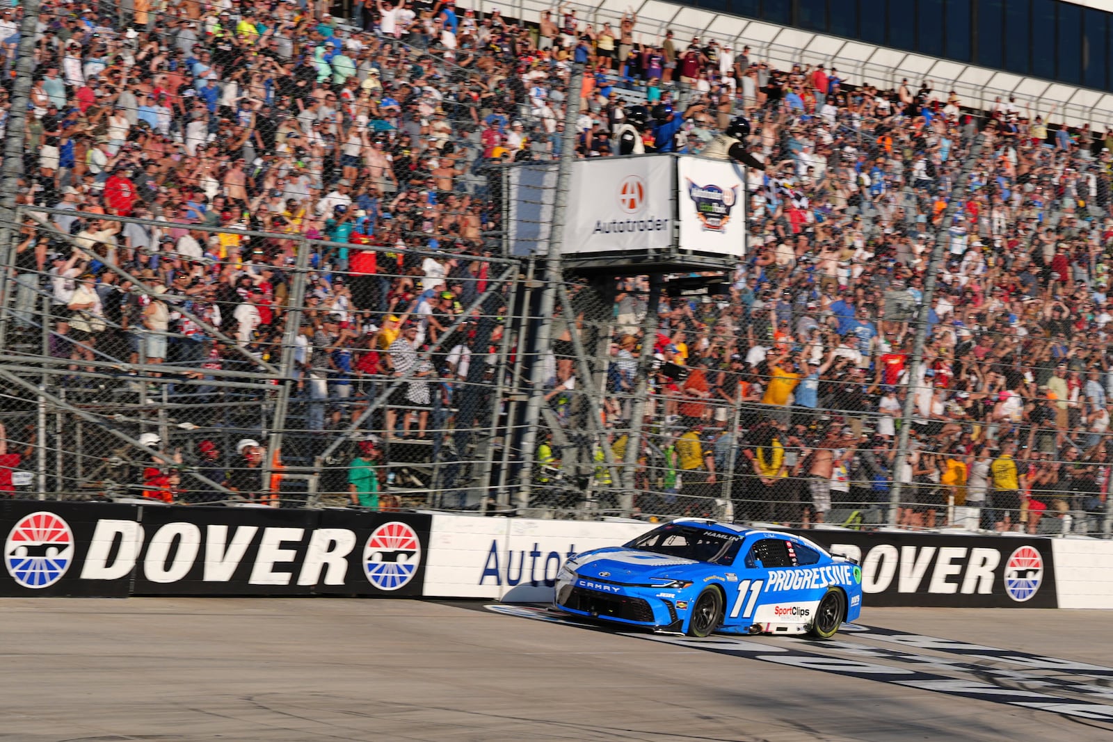Denny Hamlin crosses the finish line to win a NASCAR Cup Series auto race at Dover Motor Speedway, Sunday, July 20, 2025, in Dover, Del. (AP Photo/Derik Hamilton)