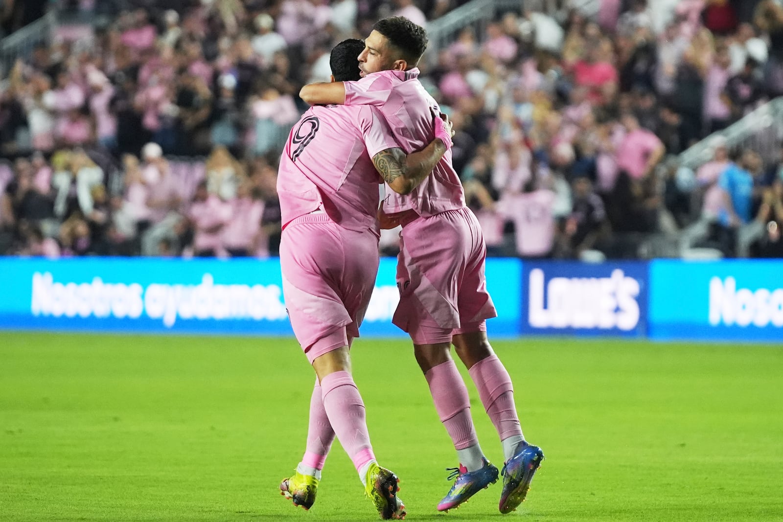 Inter Miami defender Jordi Alba, right, celebrates with forward Luis Suárez (9) after scoring a goal during the first half of a CONCACAF Champions Cup second-leg semifinal soccer match against the Vancouver Whitecaps, Wednesday, April 30, 2025, in Fort Lauderdale, Fla. (AP Photo/Lynne Sladky)