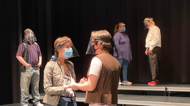 Across the region high school theater departments aren't letting a global pandemic stop their performances. Students are adjusting, say school officials, by adopting coronavirus preventive measures including masks, face shields and lots of hand sanitizer. Instead of live audiences, schools are beaming plays out over the internet. Pictured is Hamilton High School's rehearsal for Romeo & Juliet. (Provided Photo\Journal-News)