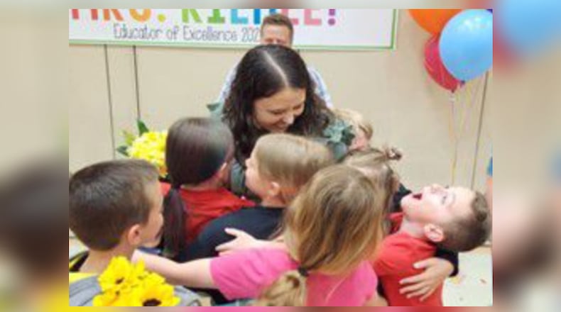 The top two Lakota instructors – and a school principal - from this school year were surprised recently by district officials who visited them to reveal their winning excellence honors in front of their students and others. The annual Lakota Educator of Excellence Awards, which are co-sponsored by the Northern Cincinnati Foundation, recognizes two teachers and a school building administrator in a long-time tradition each school year for Butler County’s largest school system. Pictured in a group hug is Melissa Riehle, 2nd grade teacher at Wyandot Early Childhood School. CONTRIBUTED