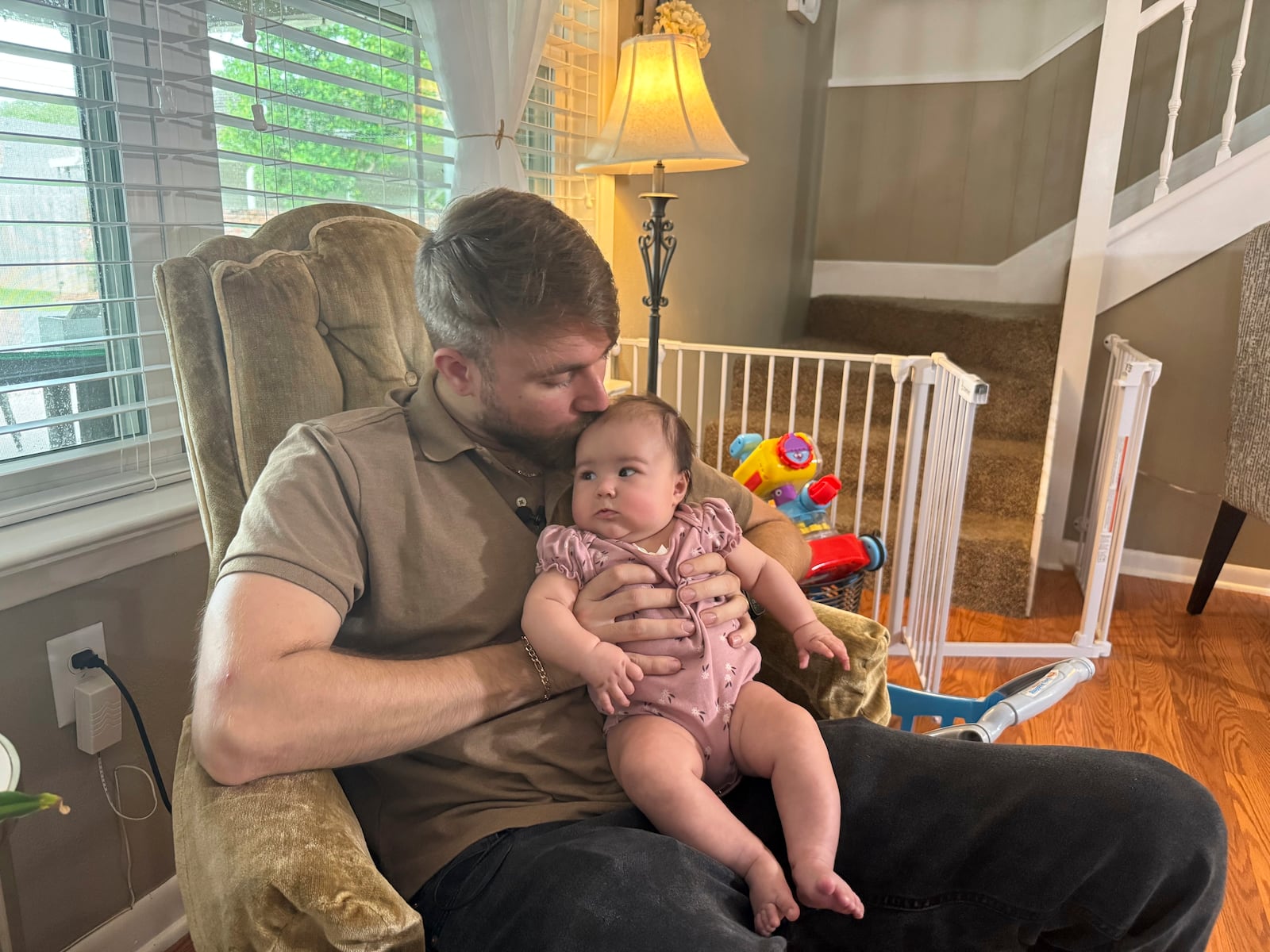 U.S. Marine Corps veteran Adrian Clouatre holds his 3-month-old daughter Lyn at their home in Baton Rouge, La. on Tuesday, June 17, 2025. (AP Photo/Jack Brook)