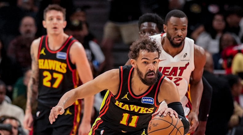 Atlanta Hawks guard Trae Young (11) drives against the Miami Heat during the first half of an NBA basketball game, Friday, Dec. 26, 2025, in Atlanta. (AP Photo/Mike Stewart)
