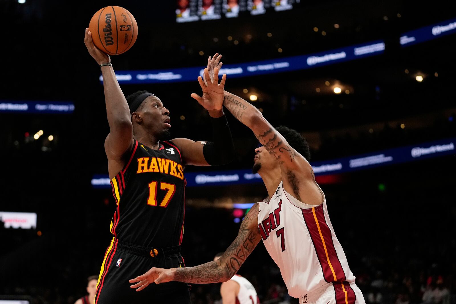 Atlanta Hawks forward Onyeka Okongwu (17) shoots against Miami Heat center Kel'el Ware (7) in the first half of an NBA play-in tournament basketball game, Friday, April 18, 2025, in Atlanta. (AP Photo/Brynn Anderson)
