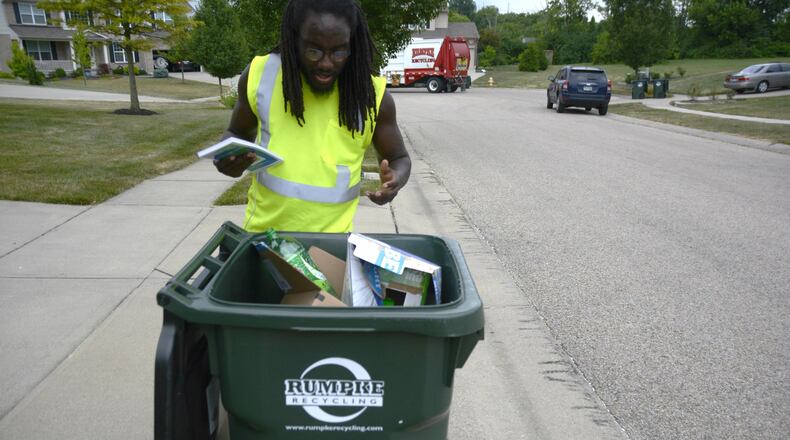 Rumpke recycling customers in Fairfield and Centerville will have their recycling carts and bins inspected to make sure they do not contain improper or contaminated items. Fairfield customers will get a one-week warning before collectors will not pick them up. Inspections, which started on Monday, July 15, will last five weeks. Pictured is Rumpke employee Canaan Orndorff inspecting a recycling cart on Monday, July 15, 2019, on Retha Drive in Fairfield to see if any improper recycling materials are included. Improper items include clothing, yard waste and any materials bagged with plastic shopping bags. MICHAEL D. PITMAN/STAFF