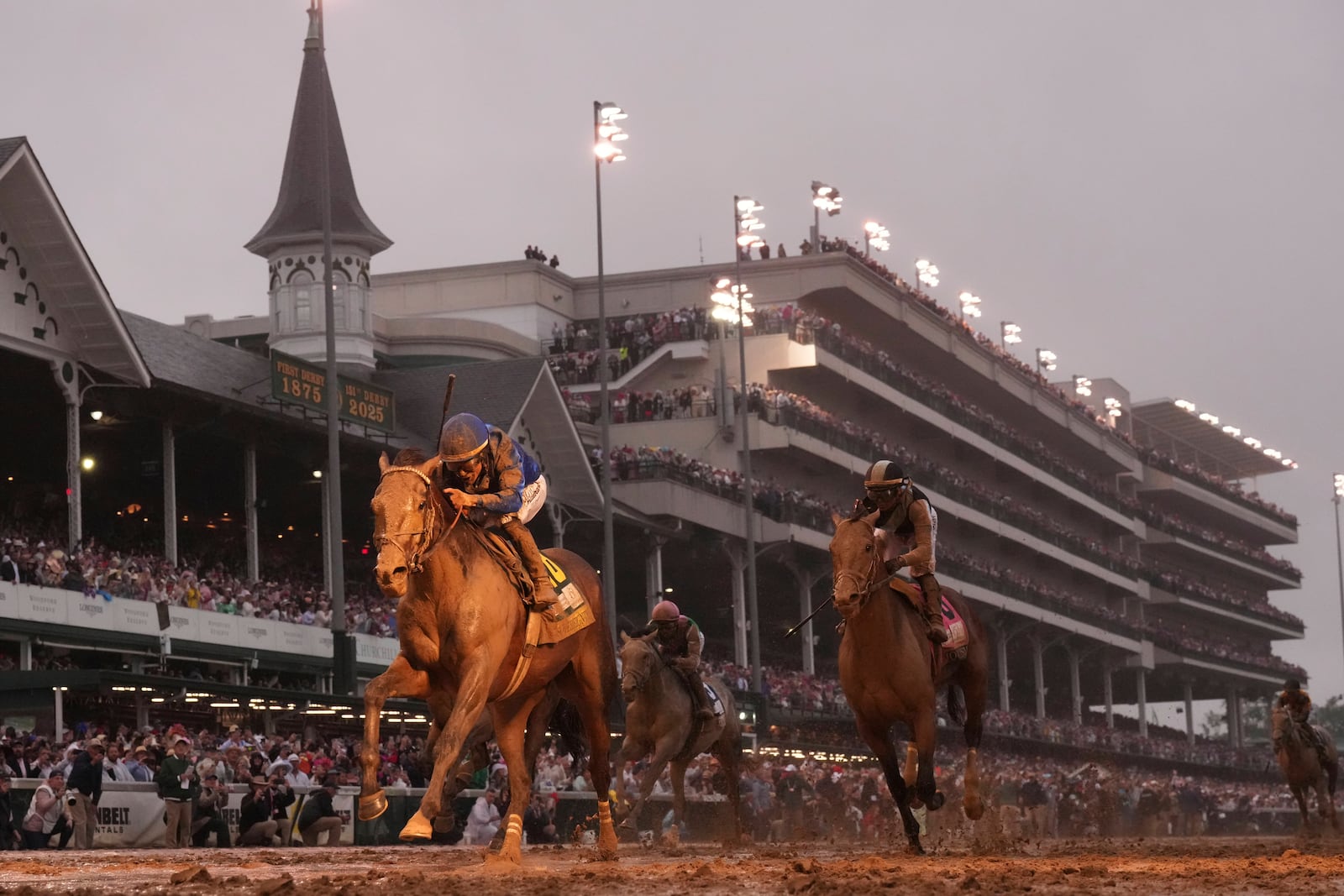 Sovereignty, ridden by Junior Alvarado, left, crosses the finish line to win the 151st running of the Kentucky Derby horse race at Churchill Downs Saturday, May 3, 2025, in Louisville, Ky. (AP Photo/Abbie Parr)