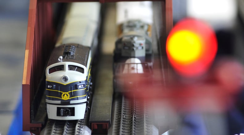 Hamilton’s holiday train exhibit allows viewers to press buttons to make them run.