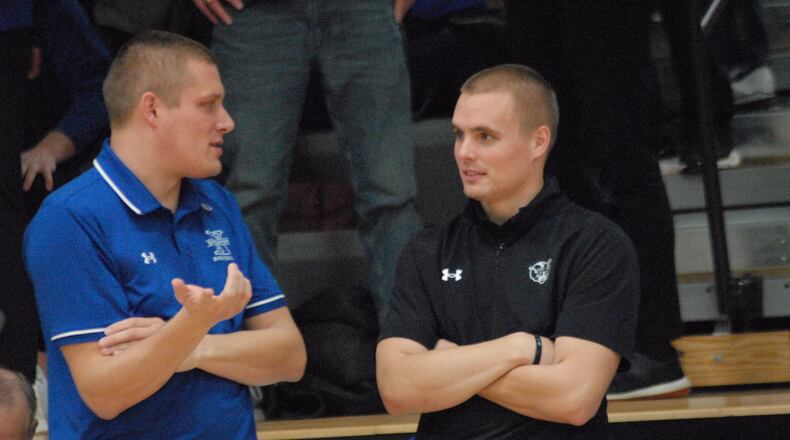 Badin coach CJ Fleming (right) and St. Xavier coach Ryan Fleming share a chat prior to their game on Tuesday night. Chris Vogt/CONTRIBUTED