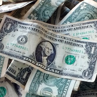 FILE - This Oct. 24, 2016 file photo shows dollar bills in New York. (AP Photo/Mark Lennihan, File)